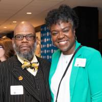 man and women pose at event in detroit